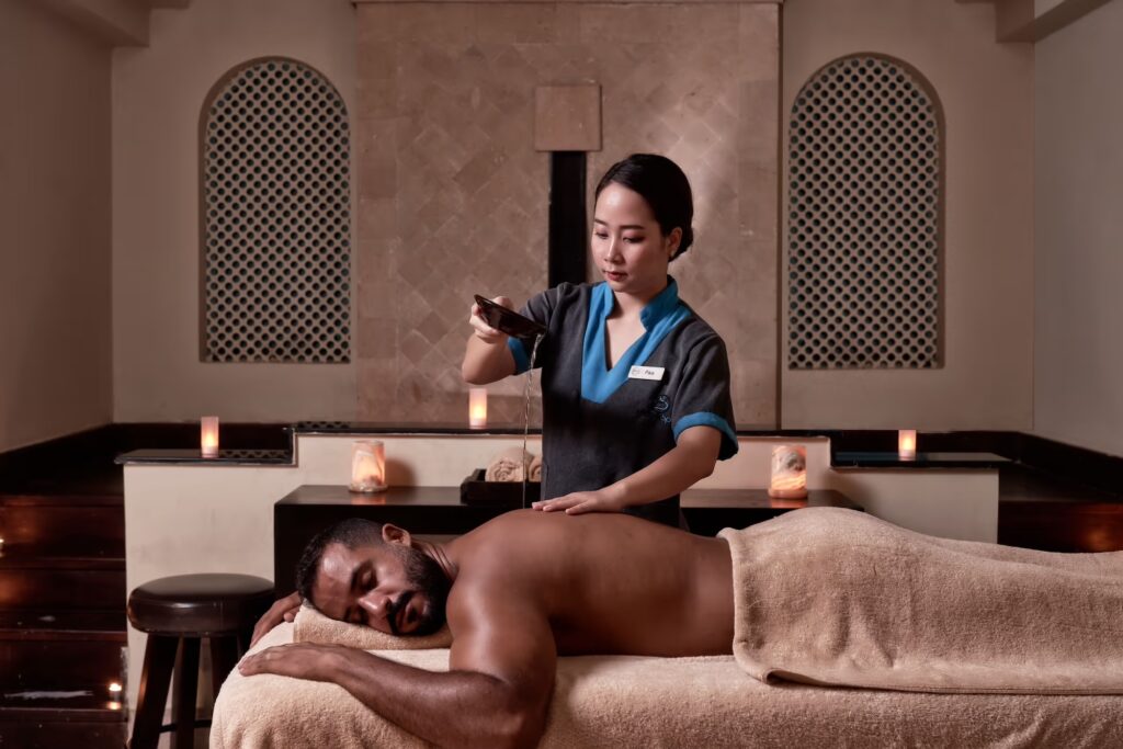 Spa therapist giving a relaxing massage in a tranquil El Gouna setting