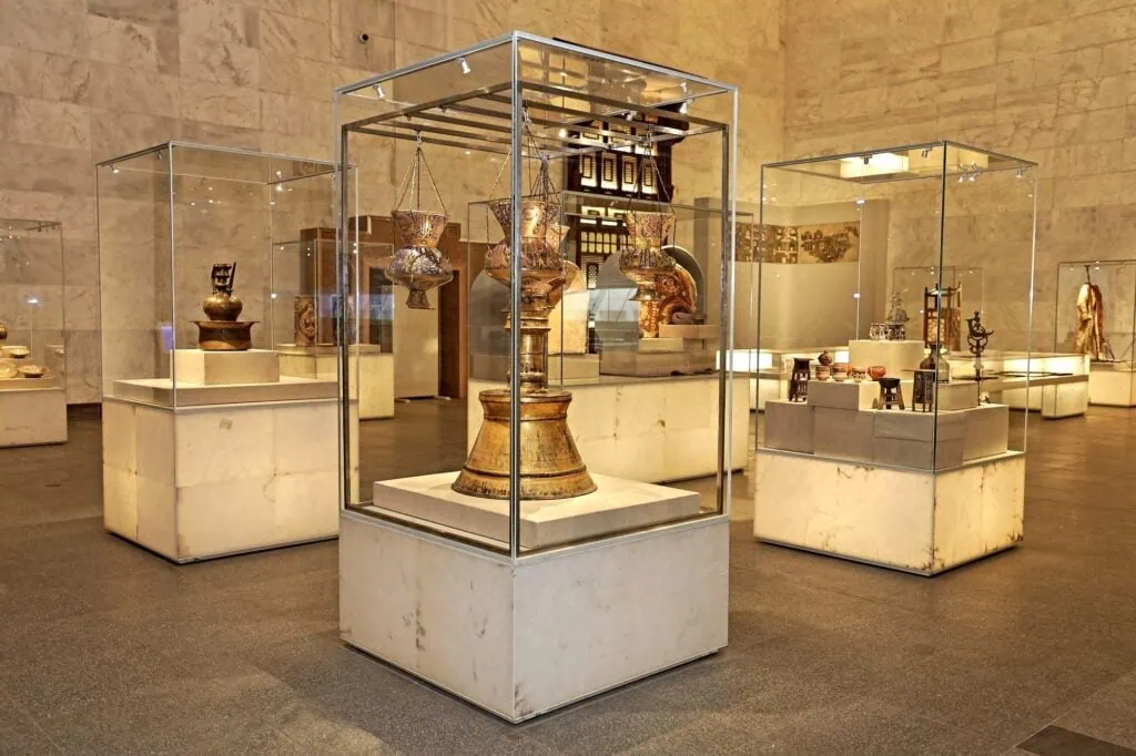 Decorative metal ceremonial lamp displayed in a glass case at the National Museum of Egyptian Civilization