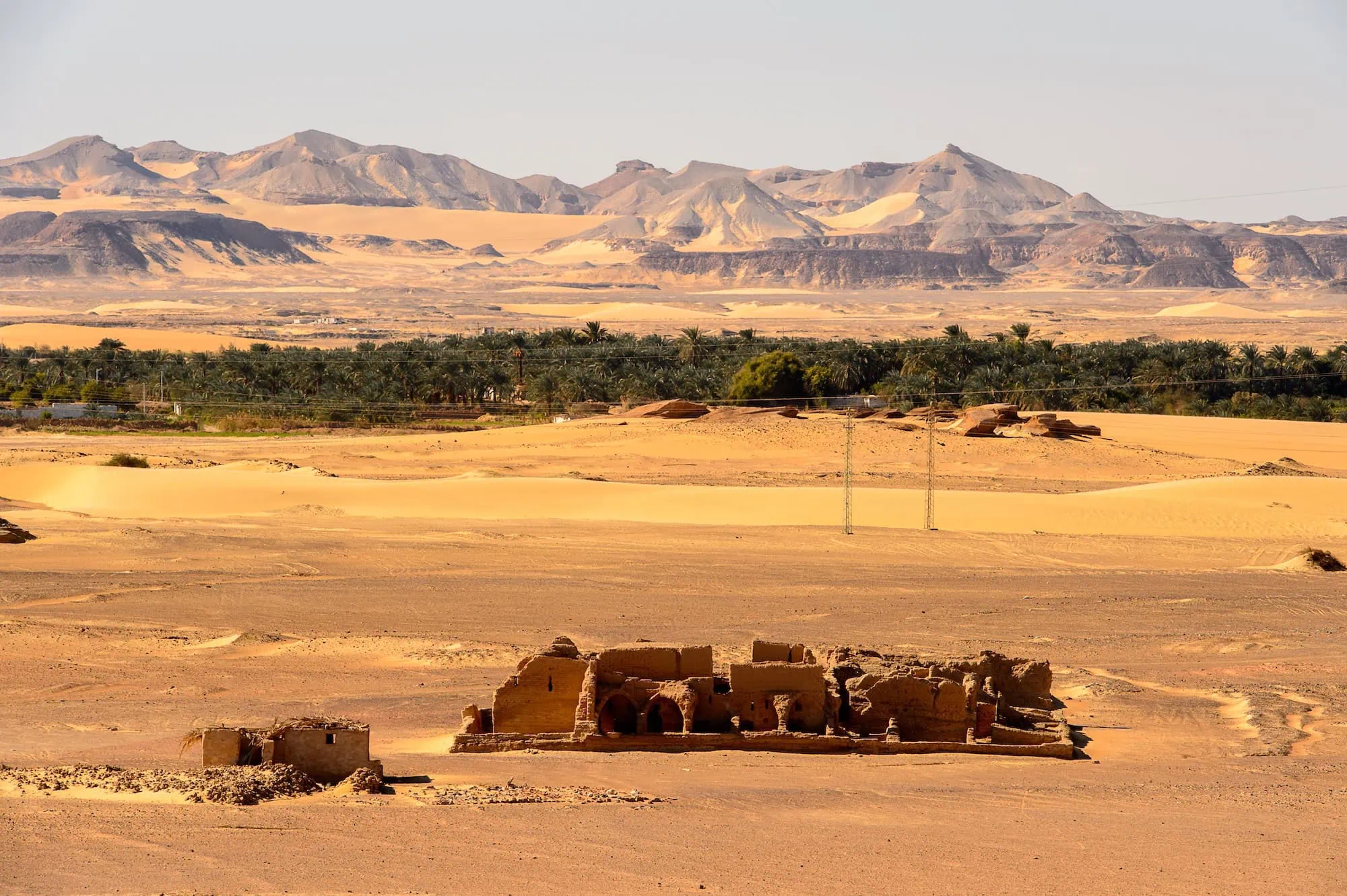 Ancient mud-brick Christian tombs at Al-Bagawat cemetery in Egypt's desert landscape