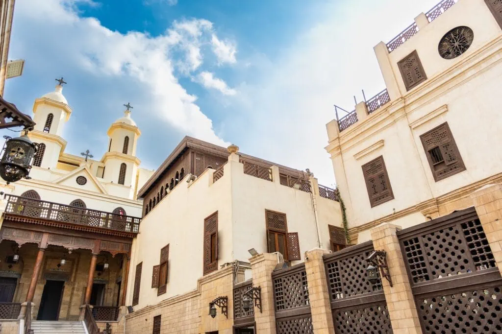 Exterior view of the Hanging Church with its elevated stone facade and arched entrance at Saint Virgin Mary’s Coptic Orthodox Church, Coptic Cairo, Cairo
